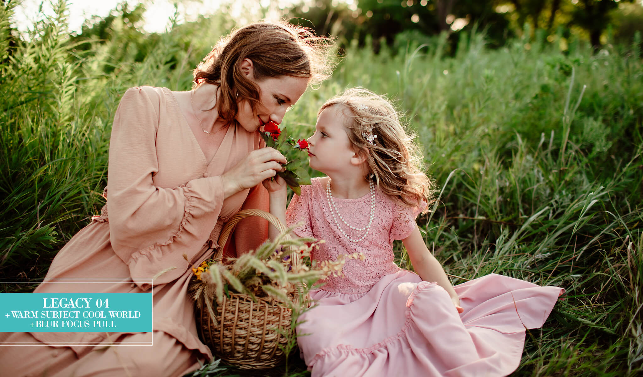A woman and a young girl in matching dusty pink dresses sit in tall green grass outdoors, each holding a small red flower, edited with Legacy Lightroom Presets from Pretty Presets