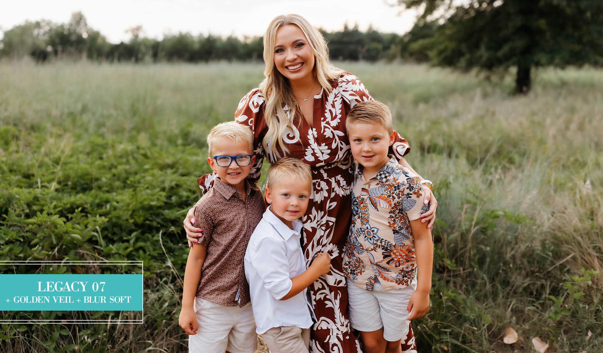 A family of four posing outdoors in a grassy field edited with Legacy Lightroom Presets from Pretty Presets