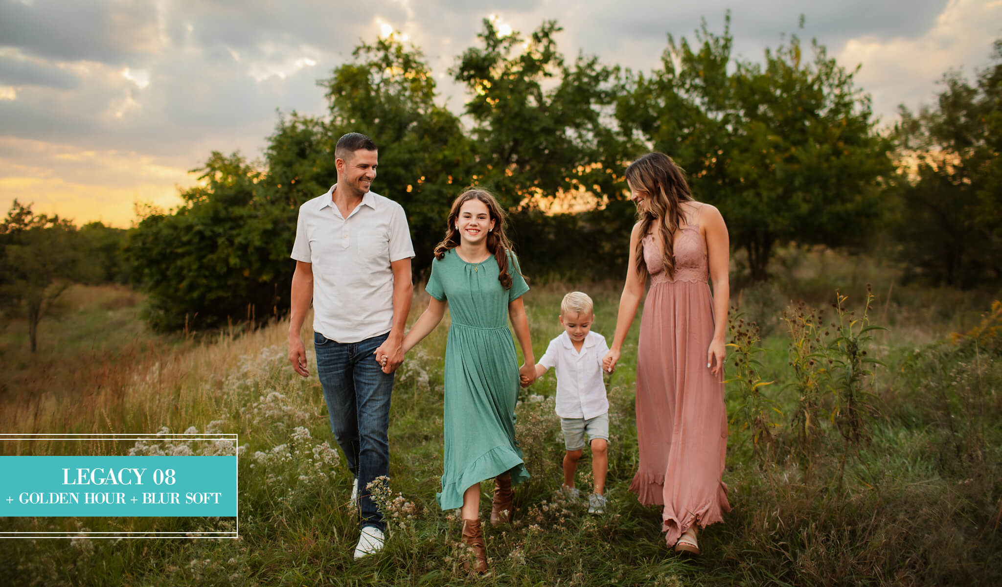 A family of four walking hand-in-hand through a grassy field at sunset, edited with Legacy Lightroom Presets from Pretty Presets